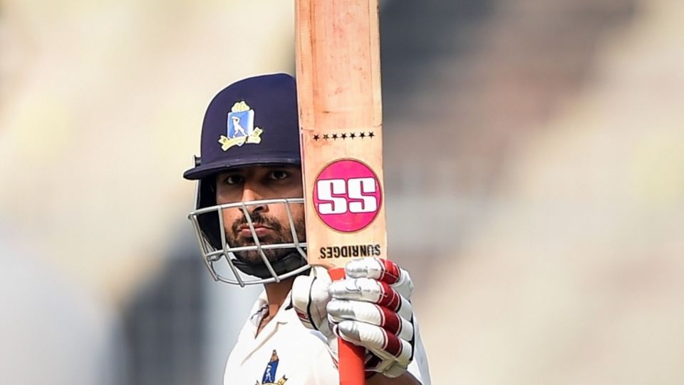 Shreevats Goswami raises his bat after reaching a hundred