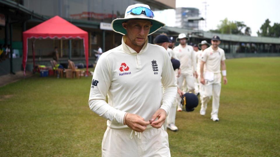 Joe Root leads his team off the field after the postponement of their Test series in Sri Lanka