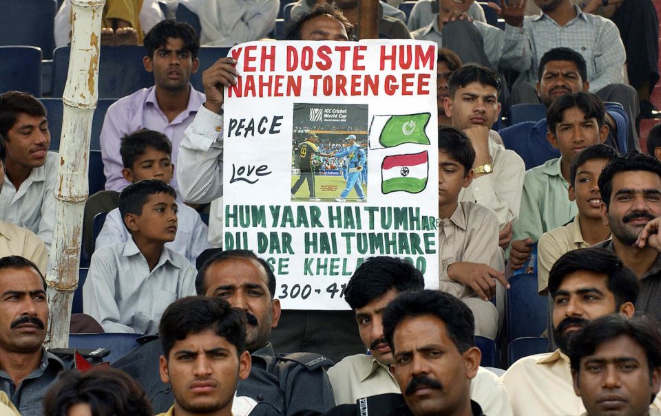 A fan displays a poster for peace at the Faisalabad Test against South Africa in 2003