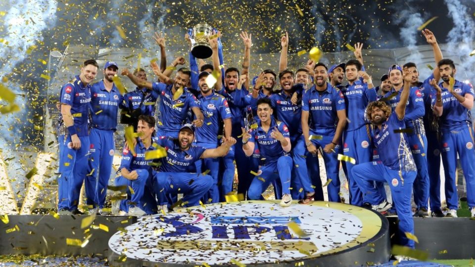 The Mumbai Indians players pose with the IPL 2019 trophy