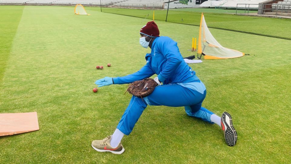 West Indies fielding coach Rayon Griffith wears PPE while conducting a drill