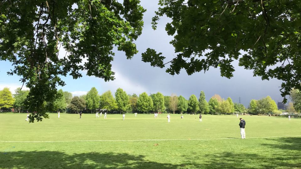 A club cricket match takes place in Springfield Park, East London