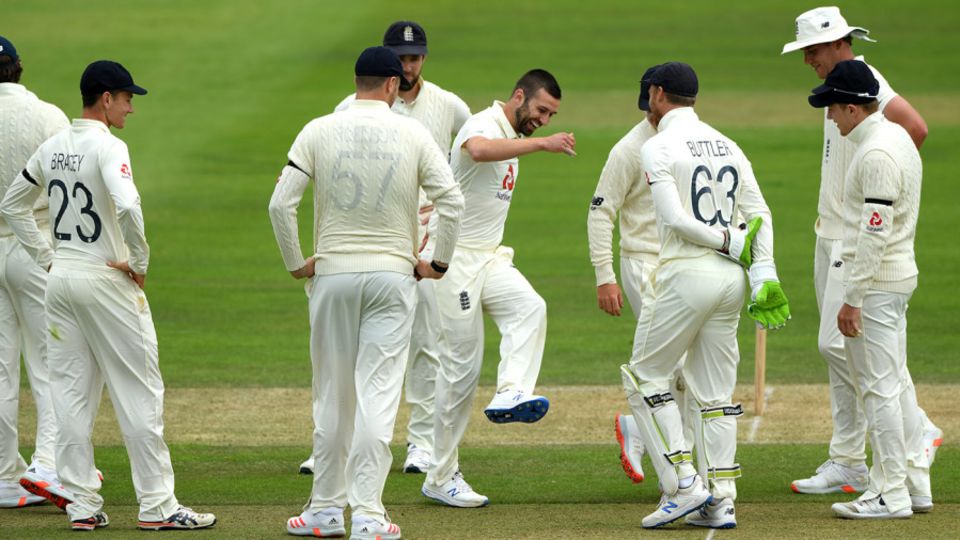 Mark Wood celebrates with team-mates after taking the wicket of Jonny Bairstow