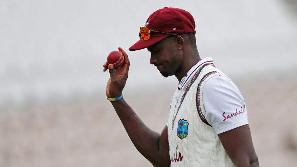 Jason Holder leaves the field with the ball after taking six wickets