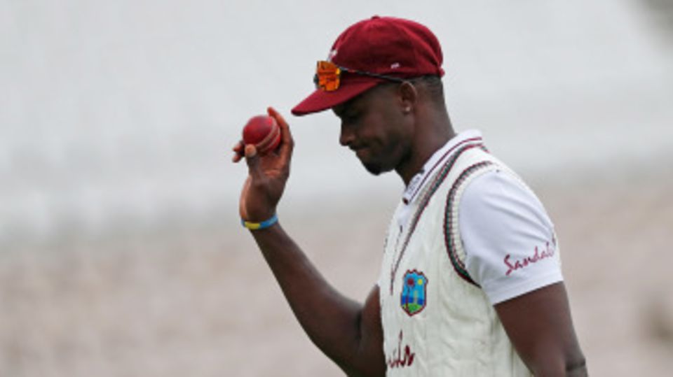 Jason Holder leaves the field with the ball after taking six wickets