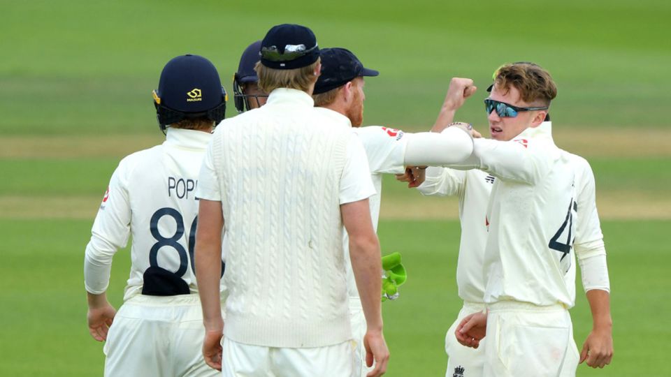 Dom Bess celebrates with his team-mates after taking the wicket of Shai Hope