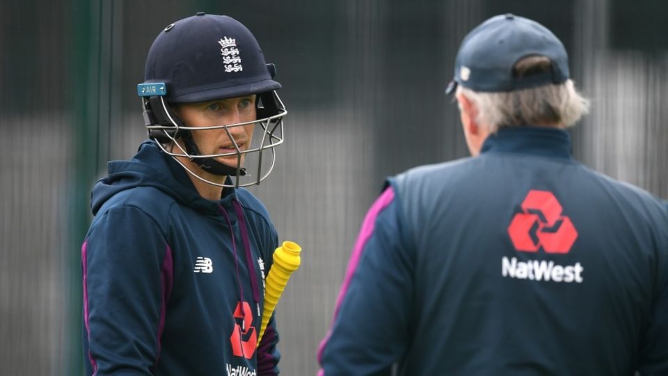 Joe Root talks to head coach Chris Silverwood during a practice session