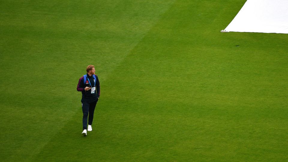 Ben Stokes walks across the outfield on a washed out third day at Emirates Old Trafford