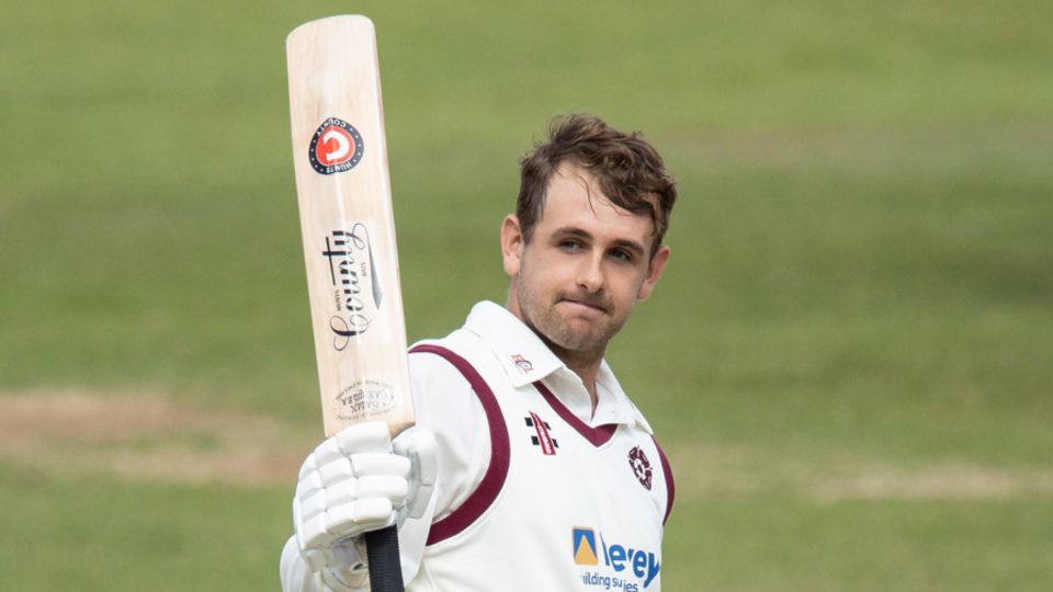 Charlie Thurston acknowledges the applause from his team-mates on reaching his century