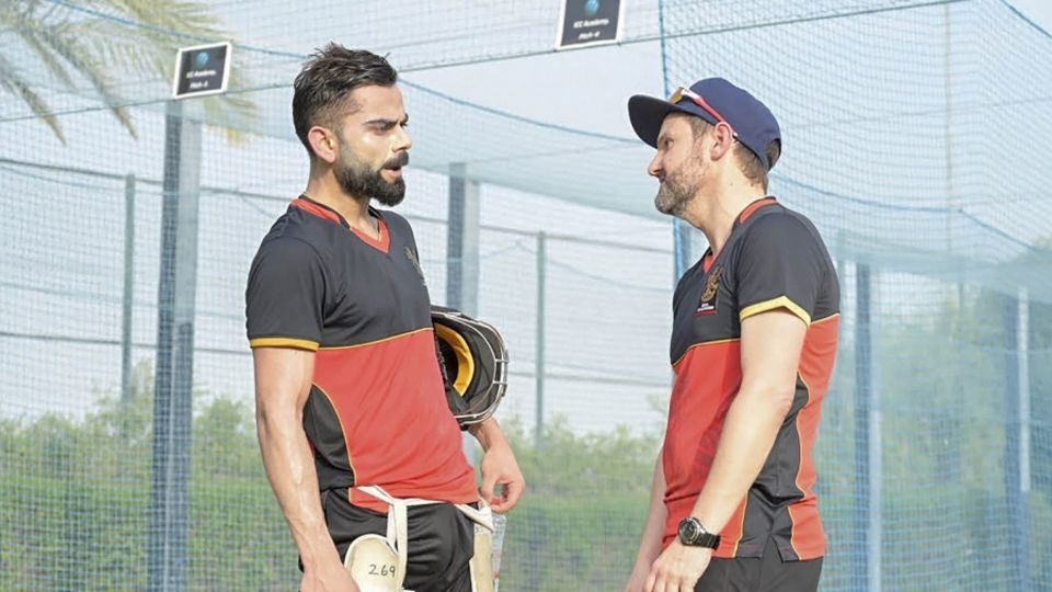 [File photo] Mike Hesson is all ears as Virat Kohli makes a point