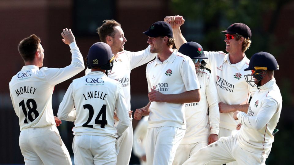 Tom Hartley celebrates a wicket with his Lancashire team-mates