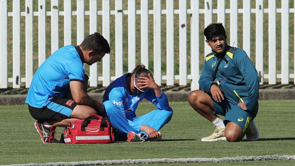 Suzie Bates sits on the boundary edge after hurting her shoulder