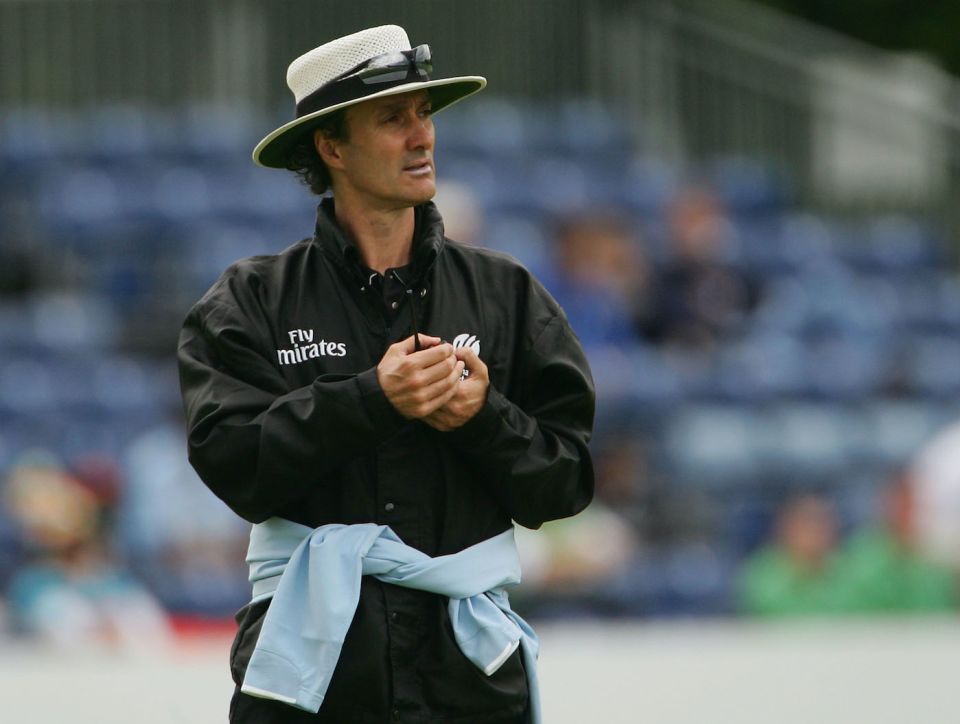 Billy Bowden cuts a sharp figure in all black, boater and sunnies