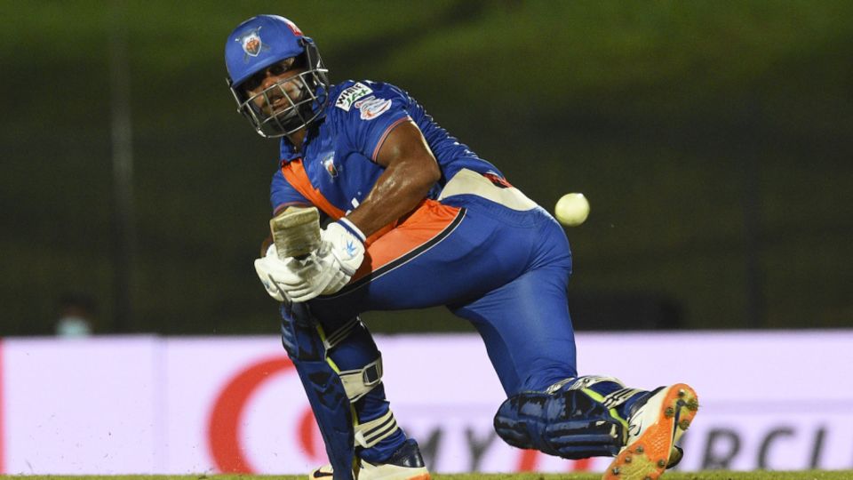 Asela Gunaratne sweeps during his half-century