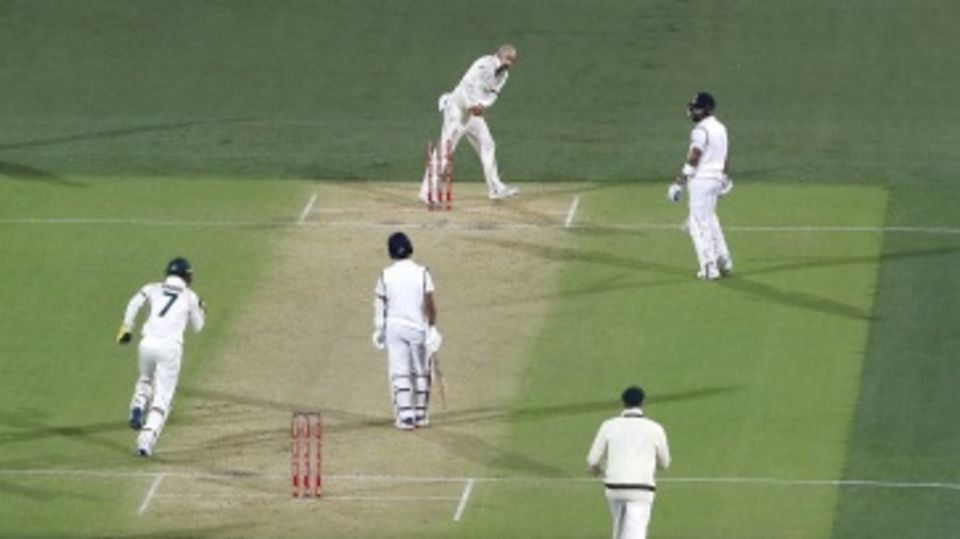 Nathan Lyon whips the bails off as Virat Kohli is left stranded mid-pitch
