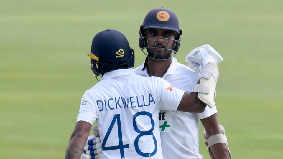 Dinesh Chandimal is congratulated by Niroshan Dickwella for his half-century