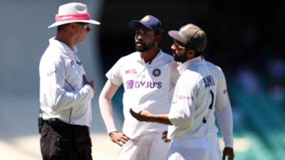 Mohammed Siraj and Ajinkya Rahane talk to umpire Paul Reiffel after spectators in the stands at SCG heckled Siraj