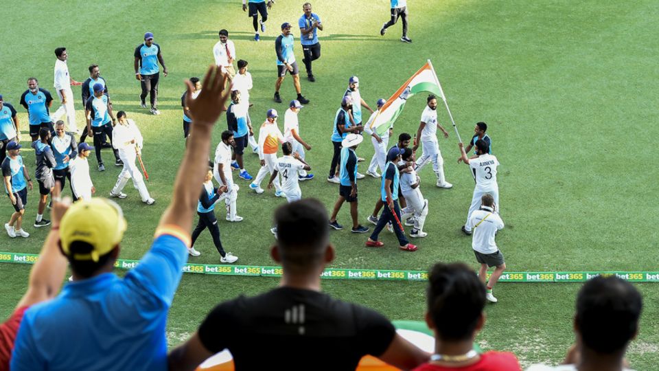 Fans greet the Indian players on their victory lap around the Gabba