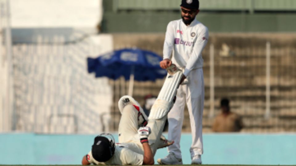 Joe Root struggled with a cramp late on day one - and got a hand from Virat Kohli
