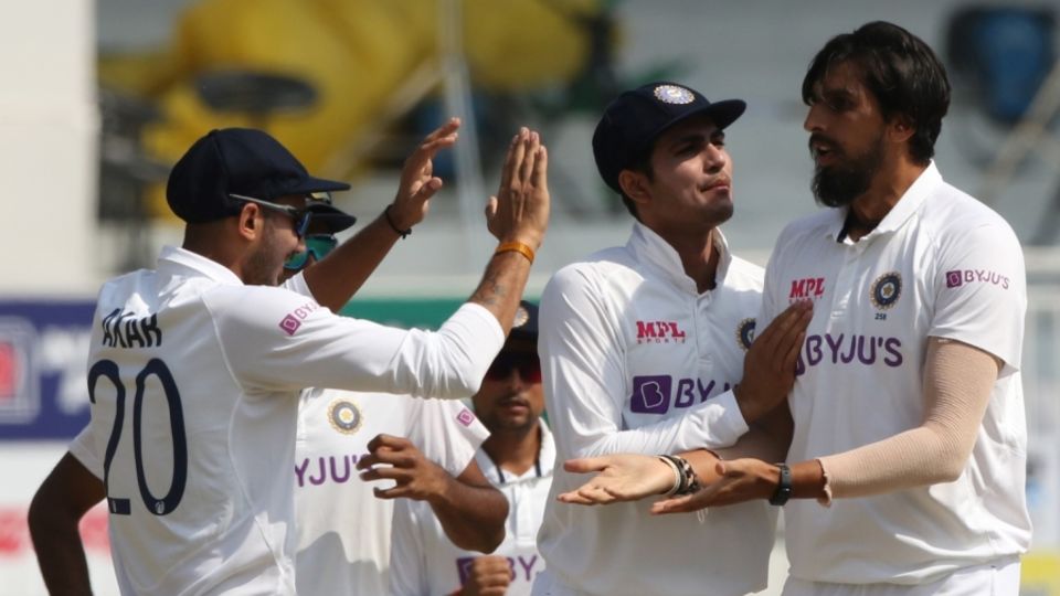 Team-mates gather around Ishant Sharma after he pinned Rory Burns for a duck