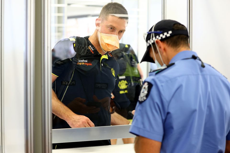 Shaun Marsh has his documents inspected at Perth airport after taking a flight from Adelaide