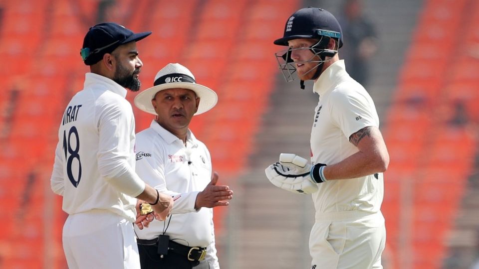 Virat Kohli and Ben Stokes exchange words during a staredown, while umpire Virender Sharma tries to keep the peace