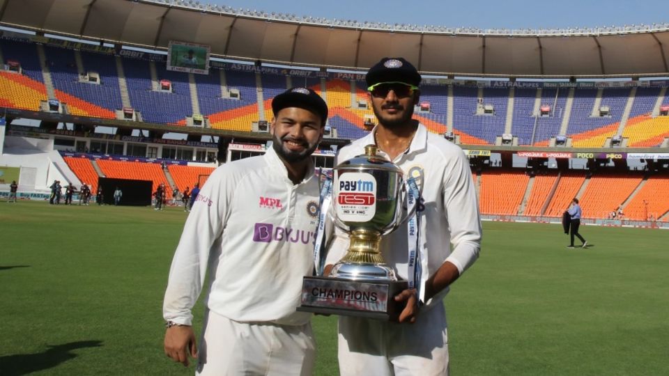 Rishabh Pant and Axar Patel pose with the trophy