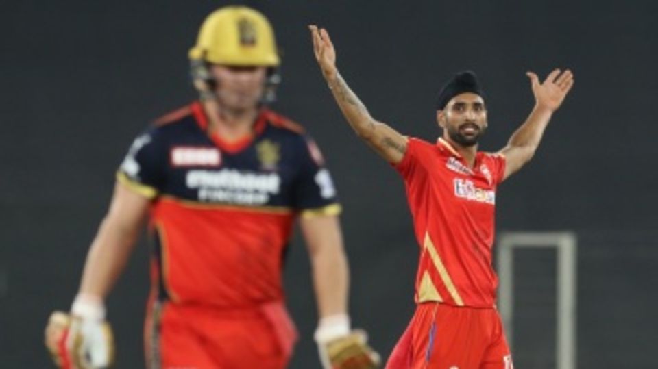 Harpreet Brar's arms are aloft after sending back AB de Villiers