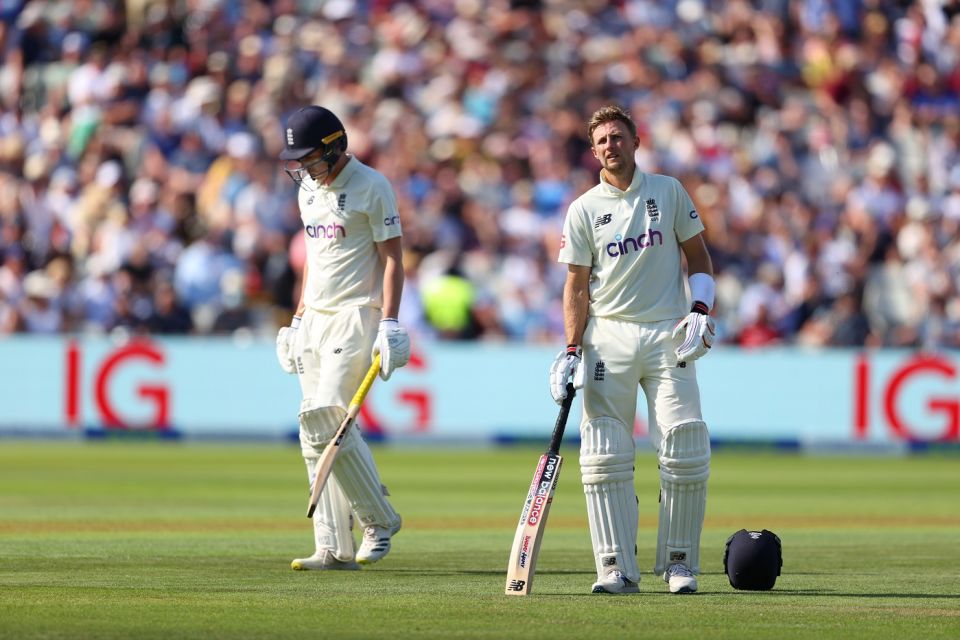 Dan Lawrence walks back for a duck as Joe Root looks on