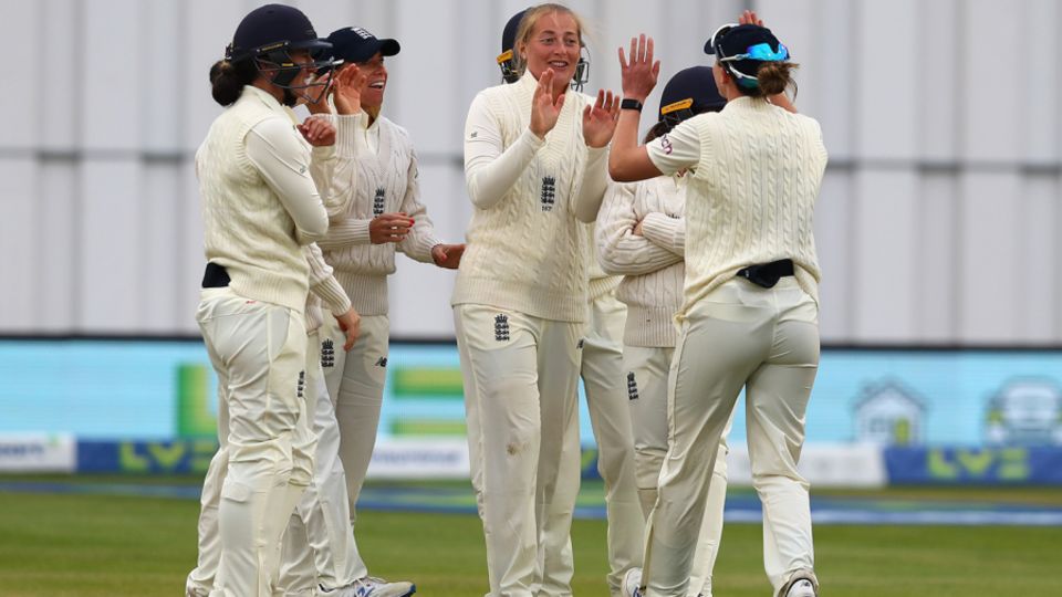 Sophie Ecclestone is mobbed by her team-mates