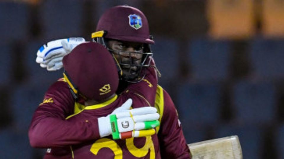 Chris Gayle celebrates his fifty with Nicholas Pooran