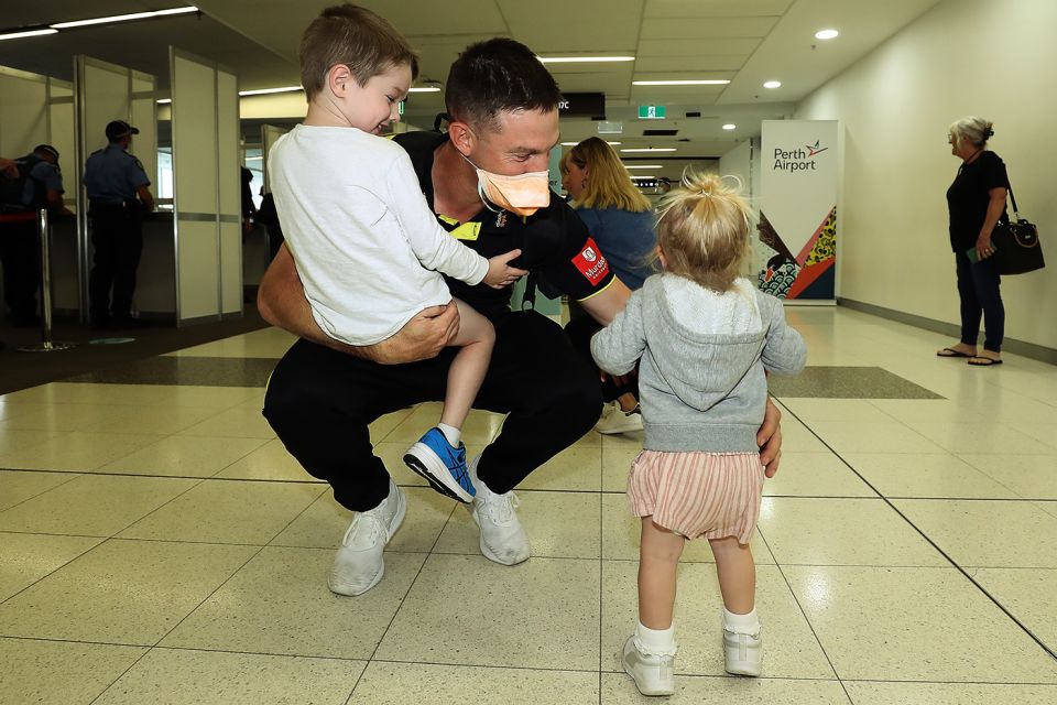 Shaun Marsh gets some time with his kids at Perth airport. Quarantine requirements have added to the amount of time players have to spend away from home