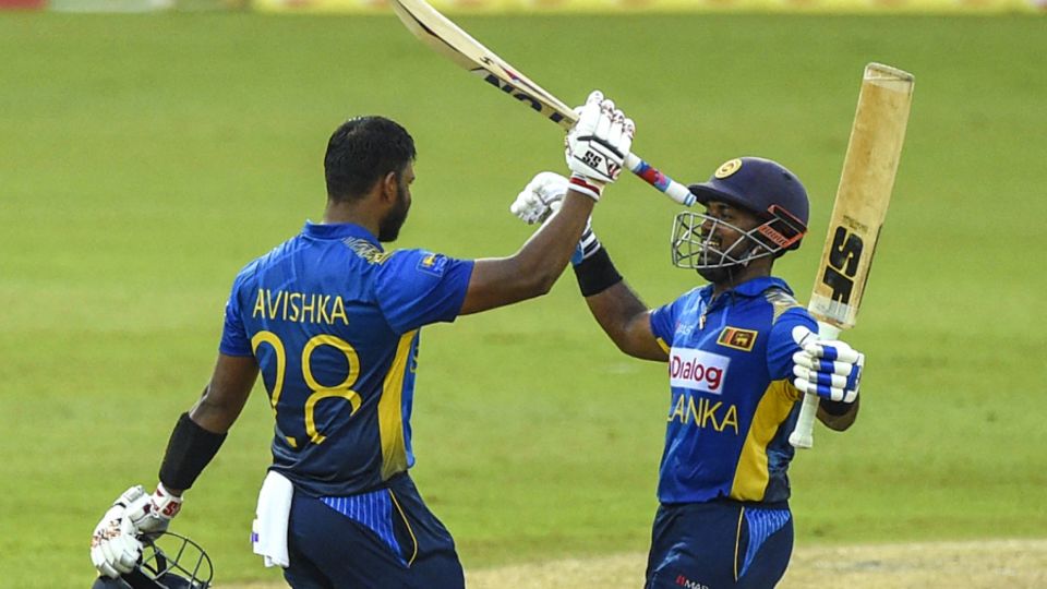 Avishka Fernando celebrates his century with Charith Asalanka