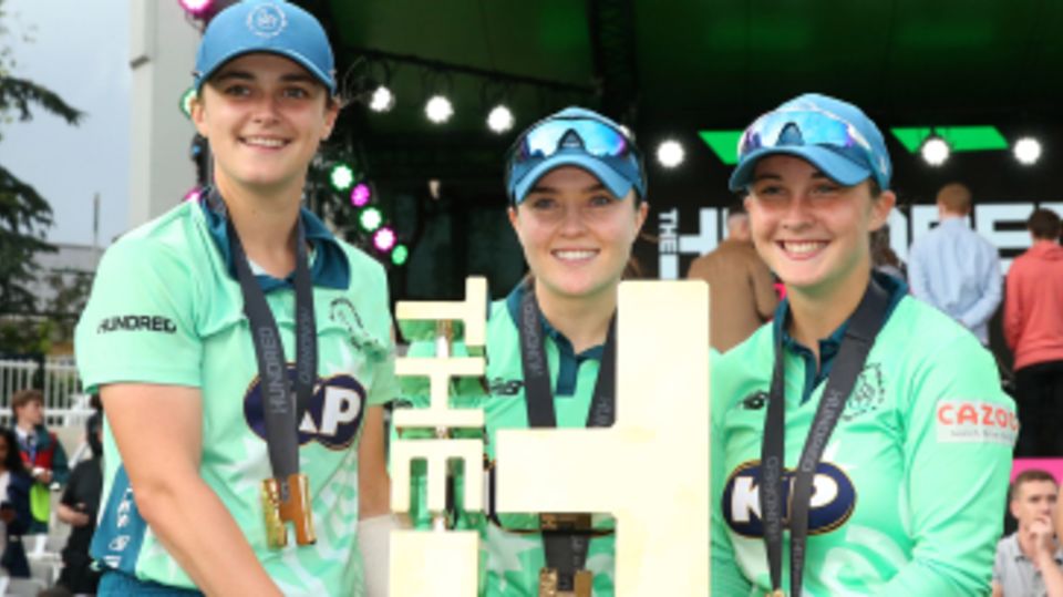 Grace Gibbs, Mady Villiers and Alice Capsey hold the Hundred trophy