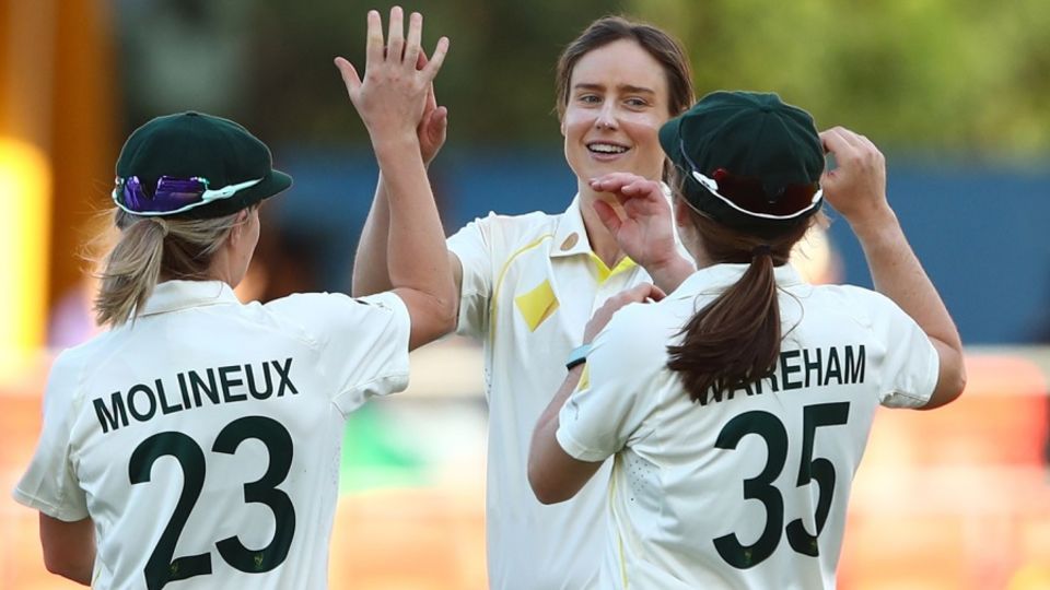 Ellyse Perry celebrates her 300th international wicket alongside Sophie Molineux and Georgia Wareham