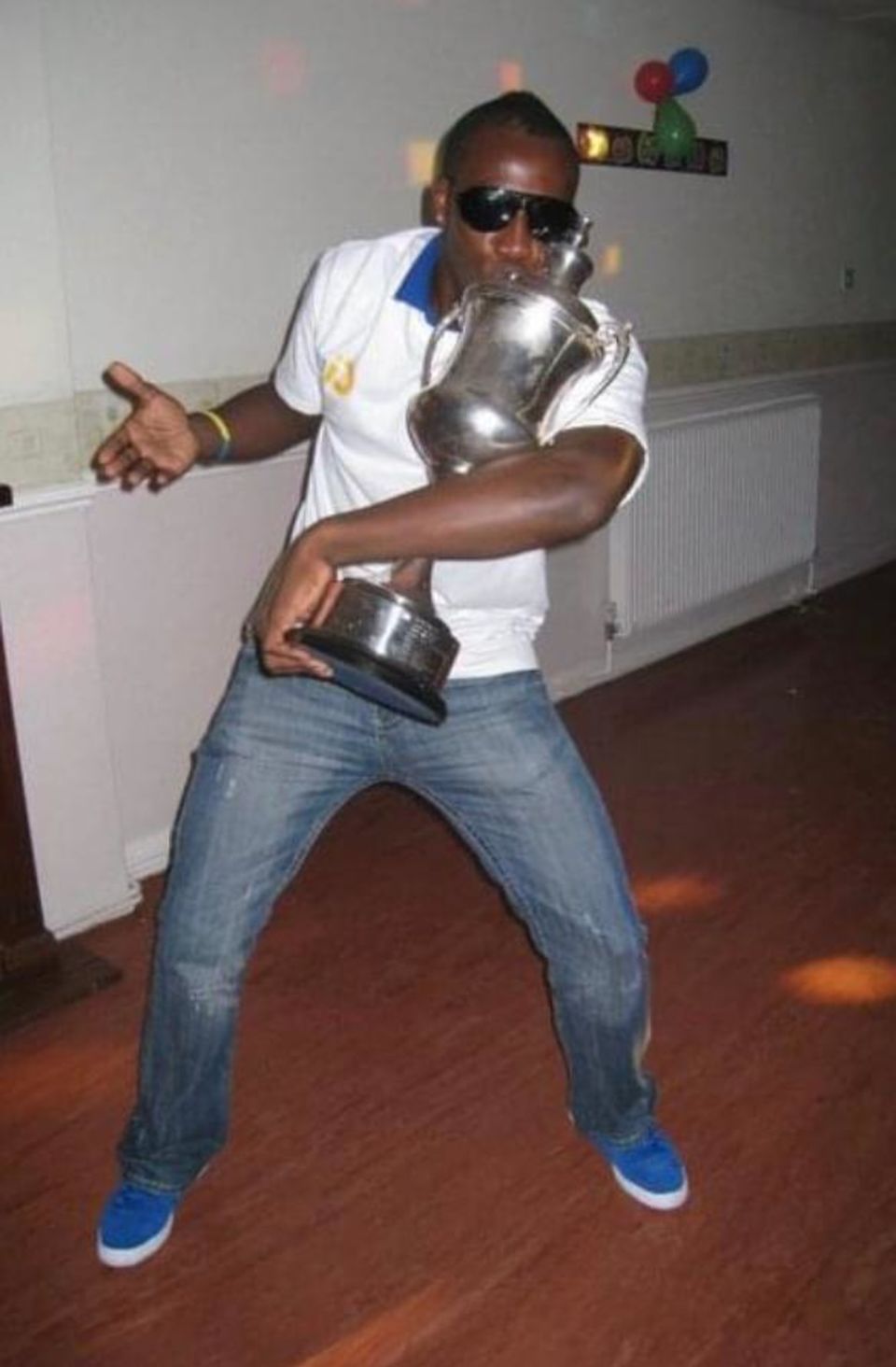 Victory dance: Russell enjoys the party after Barnards Greens won the title