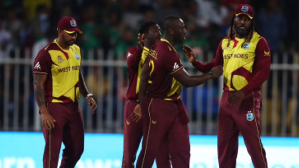 Andre Russell and Chris Gayle celebrate their thrilling win with team-mates