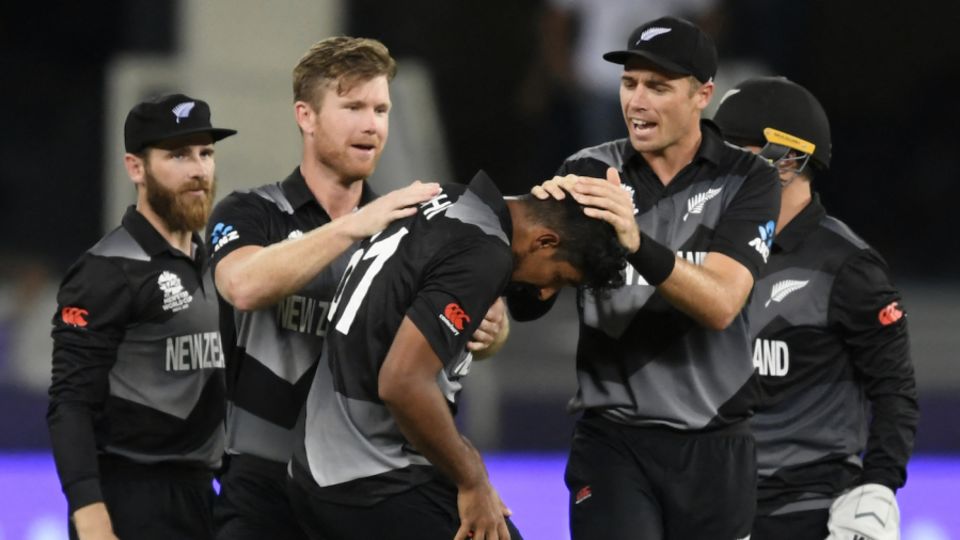 Ish Sodhi is mobbed by his team-mates after getting the wicket of Virat Kohli