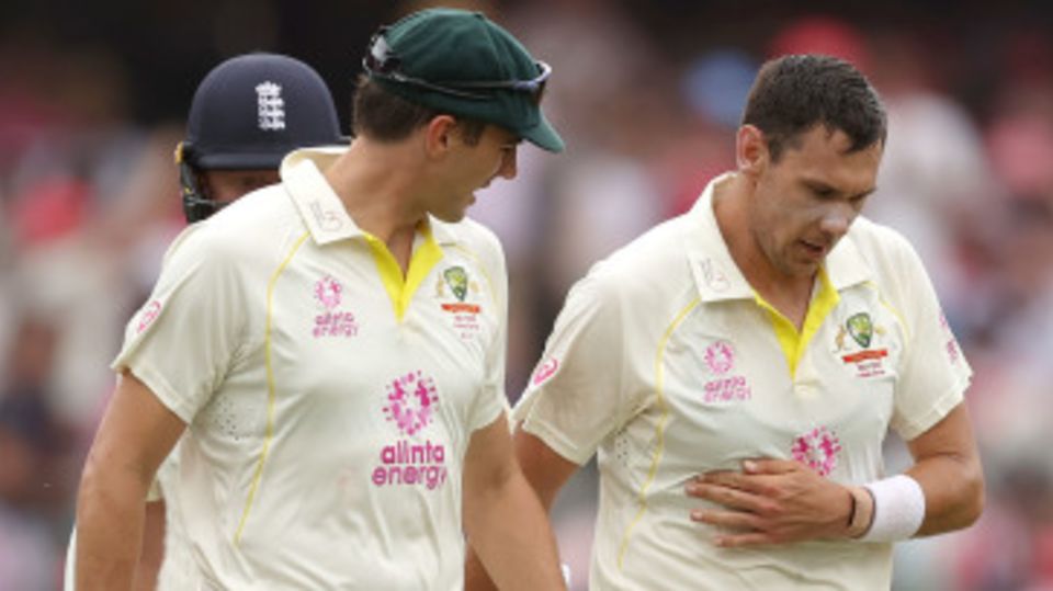 Scott Boland clutches his side after slipping on release