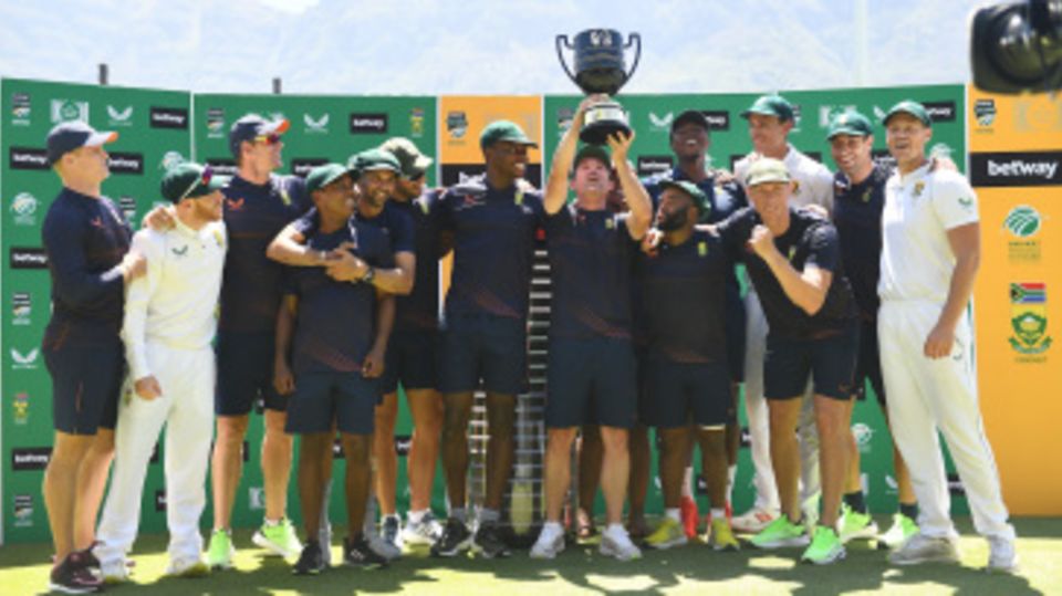 An elated Dean Elgar lifts the Freedom Trophy with his team-mates