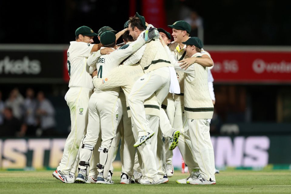 Pat Cummins is mobbed by his team-mates