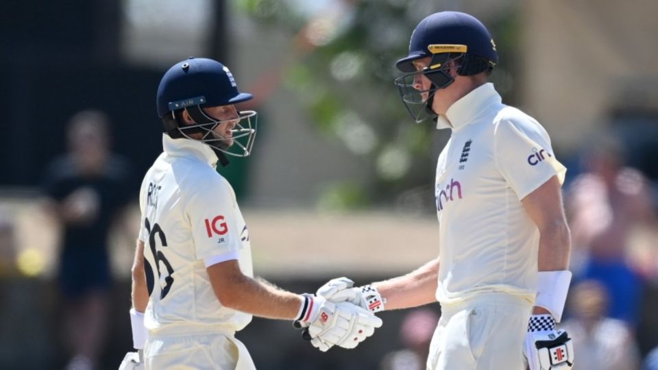 Zak Crawley is congratulated by Joe Root on reaching his half-century