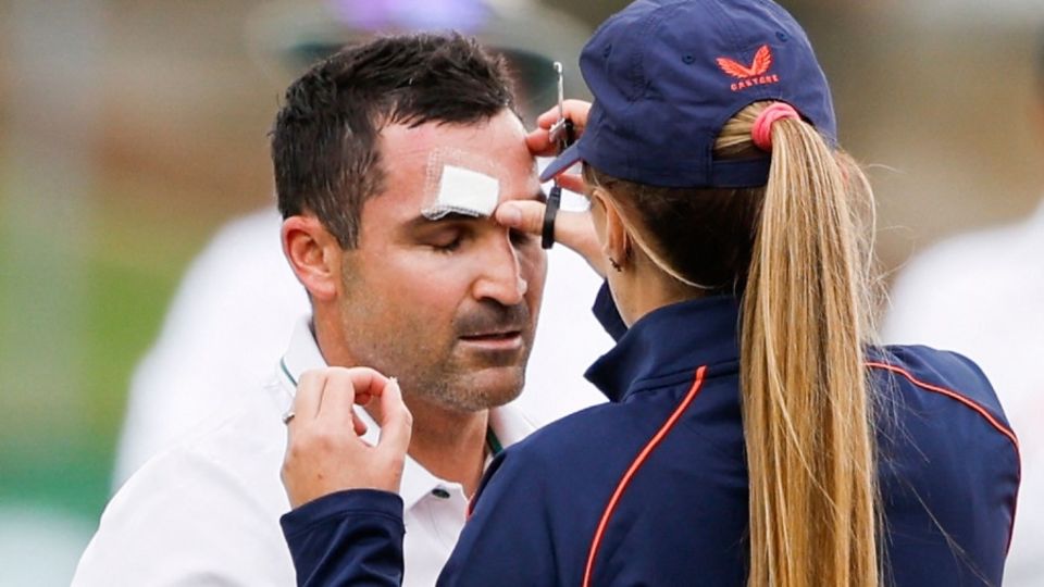 File photo - Elgar receives treatment after a blow to his helmet