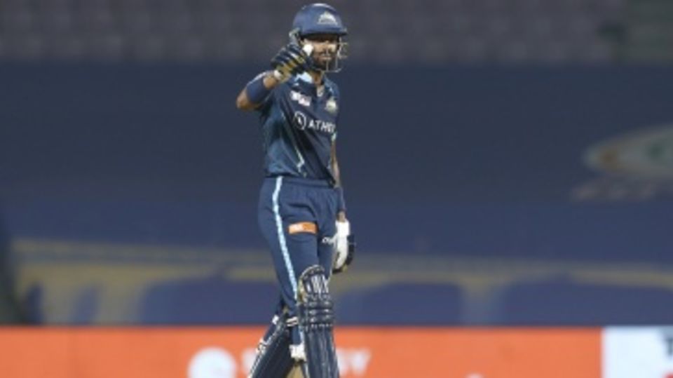 Hardik Pandya acknowledges the Gujarat Titans dugout after reaching his half-century