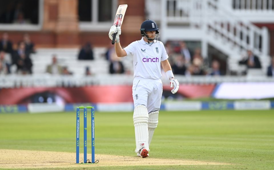 Joe Root raises his bat after his half-century