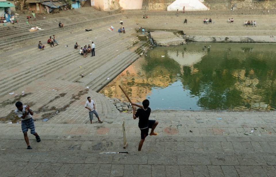 Not a level playing field: a boy pulls deftly across the Banganga Tank in Mumbai