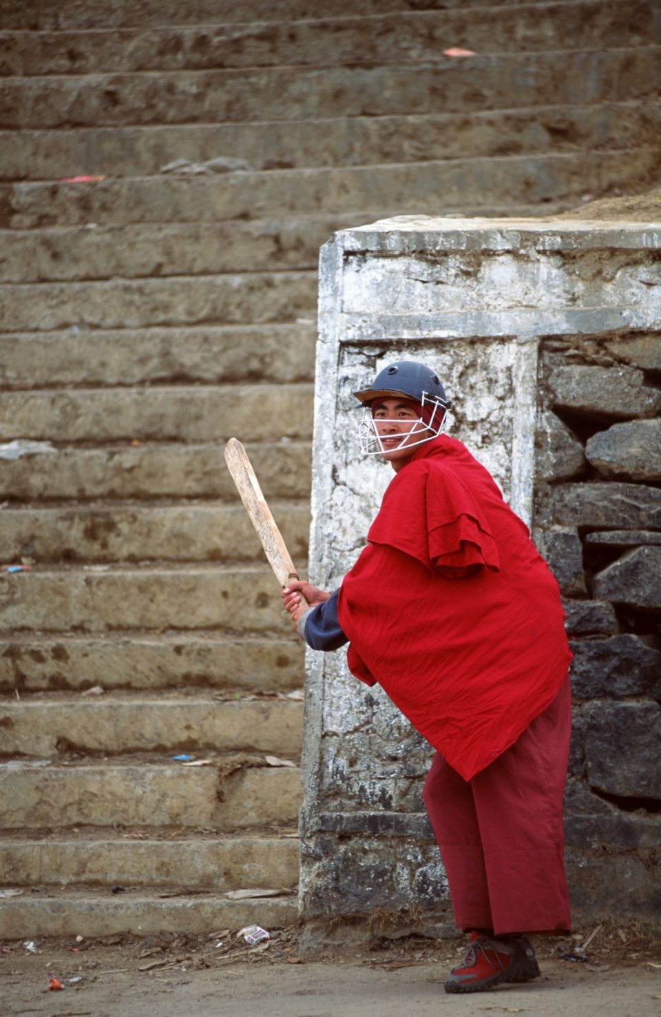 A monk uses the steps of the Tawang monastery in Arunachal Pradesh in India as a stand-in for stumps
