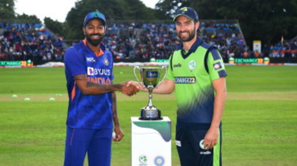 Hardik Pandya and Andy Balbirnie in front of the trophy