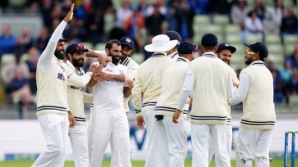Mohammed Shami is mobbed by team-mates after dismissing Jack Leach