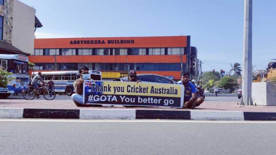 At the main intersection near the stadium, three men, who were not allowed to enter Galle Fort, sit with the poster they had brought along